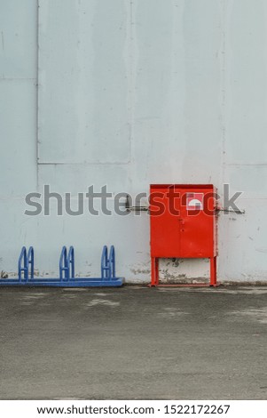 red box with fire-fighting materials at the entrance to an industrial building