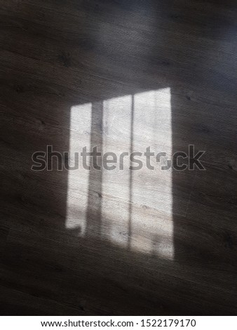 Gray windows on a wooden floor with roughness and roughness.