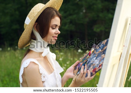 woman young girl easel paints a picture