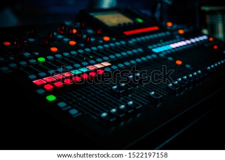 Closeup pro audio digital mixing console in dark club