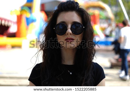 Portrait of a beautiful brunette in walking down the street, having fun and having a good time.