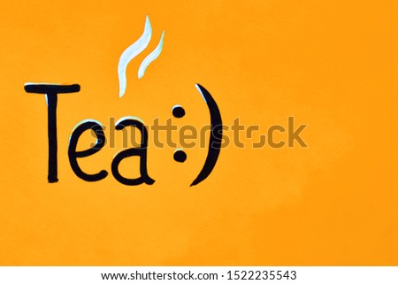 Calligraphic inscription Tea made in black paint on an orange wooden background. copy space. restaurant, cafe