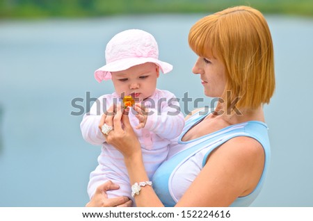 happy mother and her baby in nature
