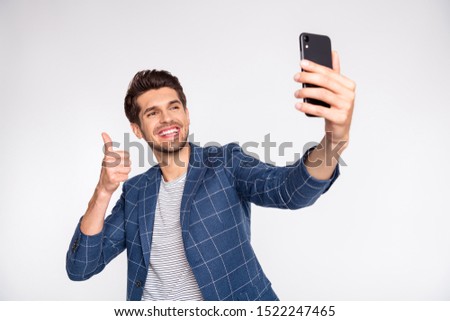 Portrait of his he nice attractive trendy stylish cheerful cheery glad businessman wearing blue checked blazer taking making selfie showing thumbup isolated over light white pastel background