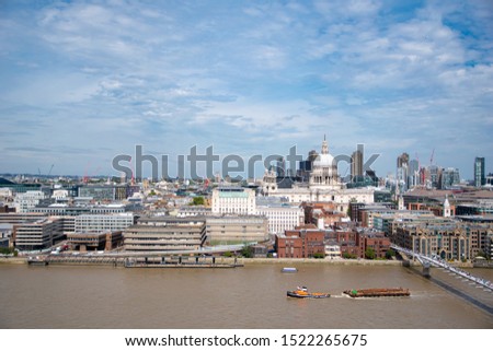 Stunning view of River Thames and St Paul's Cathedral on a bright summer day with blue sky. Aerial view of London riverside. Iconic Landmark. Travel London.
