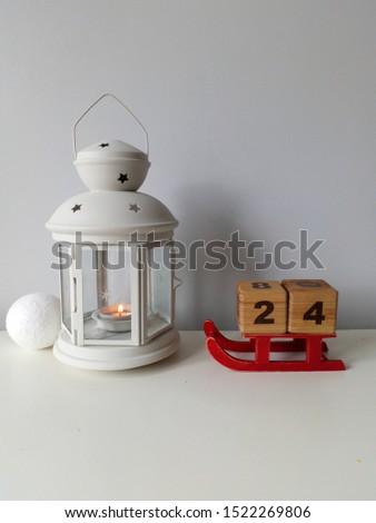 white Christmas picture with calendar cubes and candle lamp