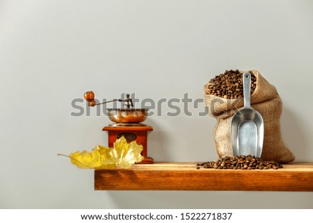 Home interior with wooden shelf and fresh coffee grains in sack. Free space for your decoration. 