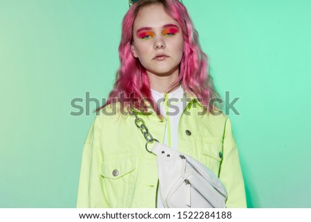 young woman looking at the camera in bright clothes