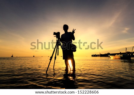 The Photographer takes a good shot on the Huahin beach, Thailand