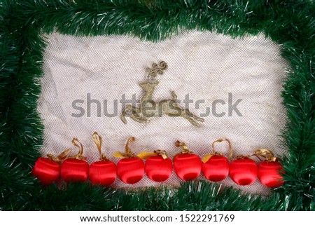 Winter holiday background. Border with Christmas tree branches and ornaments isolated on whitch. Fir needles garland, frame with streamers. Great for New year cards, banners, headers, party posters.