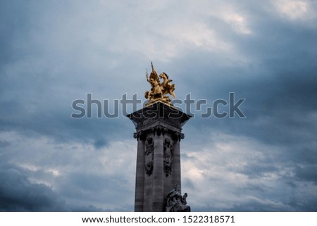 Statue at the top of the column at Pont Alexandre III bridge (París, France)