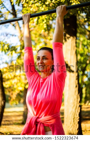 Woman in a pink sports outfit exercising in Kosutnjak park