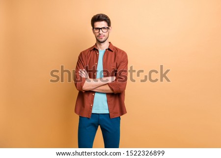 Portrait of his he nice attractive content successful serious brunet guy executive experienced finance assistant folded arms isolated over beige color pastel background