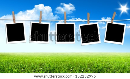 Photos frames hanging in the rope on a sky, summer day