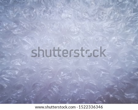 Bubble wrap. Plastic packaging material. Close-up photo. Free antistress. Abstract light, white background
