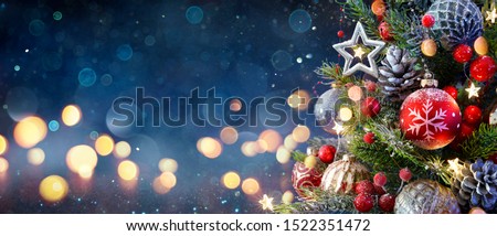 Christmas Tree With Baubles And Blurred Shiny Lights
