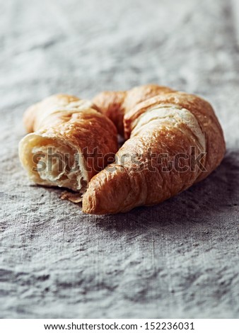 Croissant on linen cloth. Sweet dessert. Close up. 