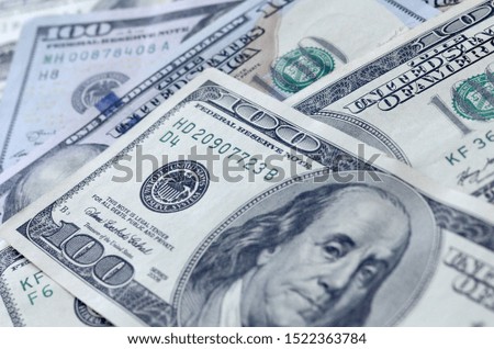 Abstract textured backdrop with many hundred dollar bills