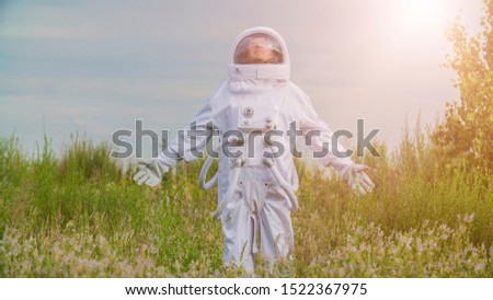 Astronaut returned to earth on the background of nature