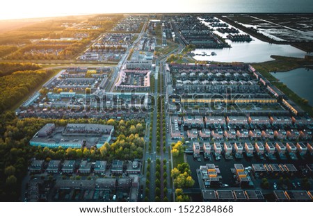 Modern suburban district Noorderplassen in Almere, The Netherlands. Situated on Flevoland polder between nature reserves Lepelaarsplassen and Pampushout. Aerial shot.