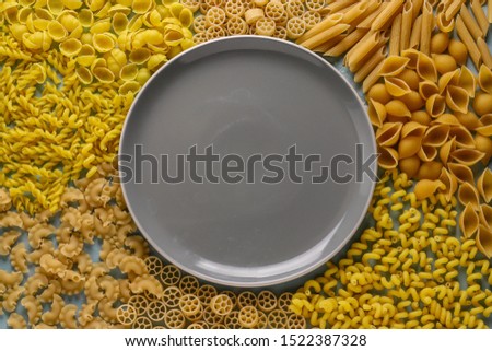 Assorted Italian pasta: Penne rigate, Rotelle, Conchiglie, Cavatappu, Fusilli, Cellentani, horizontal orientation, top view, copy space