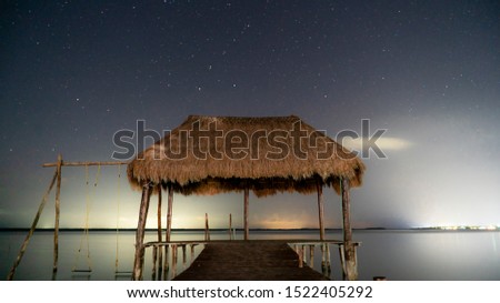 Starry night at Bacalar lagoon lake