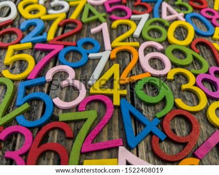 photograph with many multicolored numbers and gray background