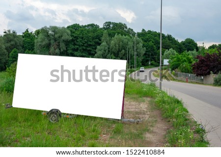 Blank white portable billboard mockup mounted on the trailer