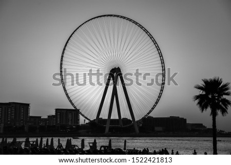 Beautiful view of Dubai Eye during sunset in black and white photo version.