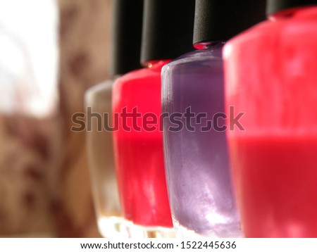 Close up of 4 nail polish bottles. Photo shows manicure concept.