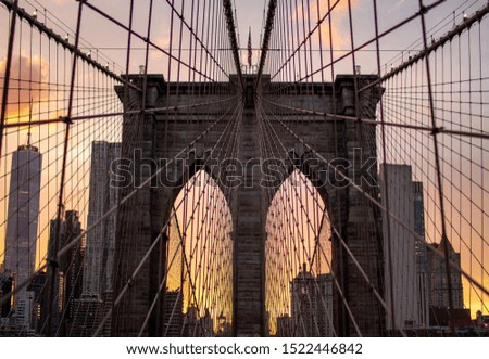 Brooklyn bridge at sunset in the summer with all lines leading to American flap