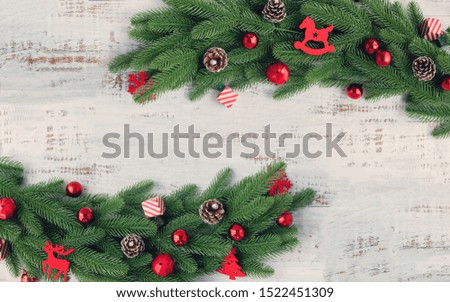 Christmas border background with decorations and wide arch shaped leaf frame on white background.