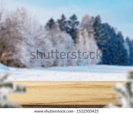 Merry christmas and happy new year greeting background with table .Winter landscape with snow and christmas trees