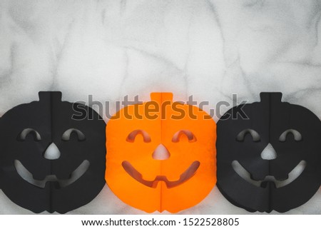Halloween background of paper pumpkin. Multicolor origami. Top view. Holiday decoration. Festive card, frame with text space. Celebration banner. Copy space. Paper composition.