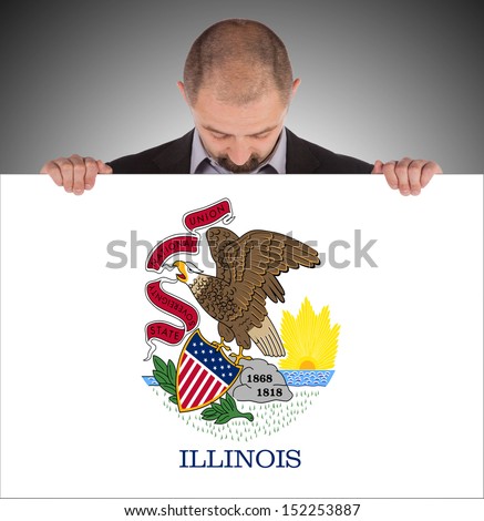 Smiling businessman holding a big card, flag of Illinois, isolated on white