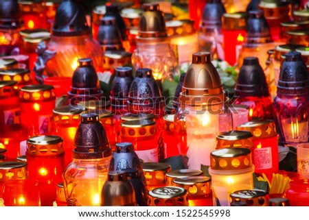 Lots of burning grave candles,  background. All Saints Day. Selective focus