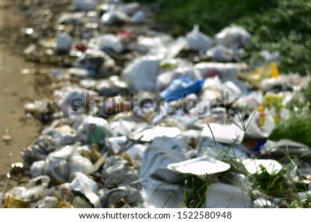 blurred picture of  plastics and other deadly wastes on a road side.