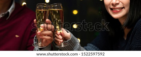Christmas dinner couple. Mixed raced couple, white man, asian woman sitting together for christmas dinner. Cheering champagne  together. Banner frame.
