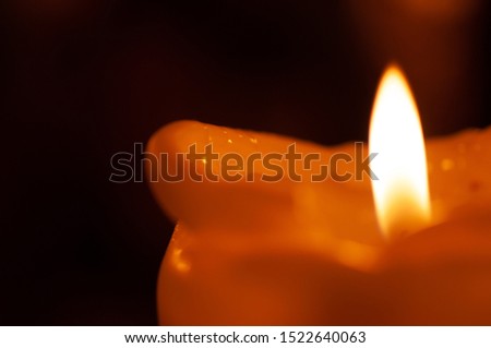 One candle flame at night closeup - isolated, macro.