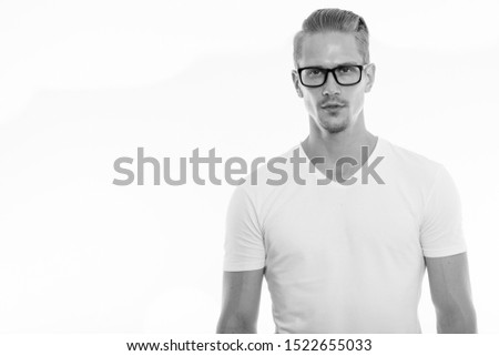 Studio shot of young handsome man wearing eyeglasses
