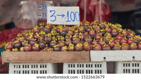 Mangosteen fruit for sale, at a local food market in Thailand.