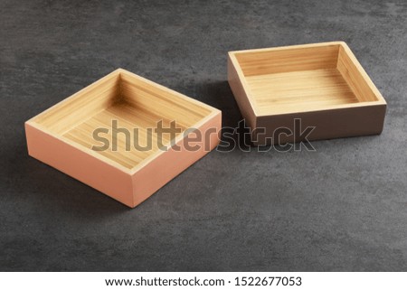 Wooden trays on the gray texture with copy space