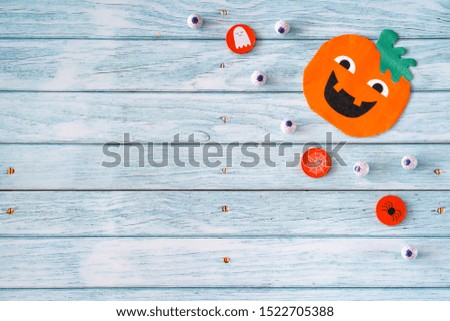 Halloween sweets and pumpkin on blue wooden background