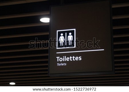 Label of symbol of toilet for men and women on blue plate, direction  sign and navigation pointer WC restroom in the building, airport, station