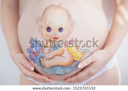 Beautiful drawing on the stomach of a pregnant woman in the form of a cheerful baby