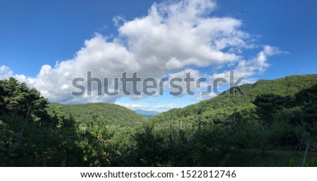 landscape photography of the beautiful mountain with white clouds and blue sky