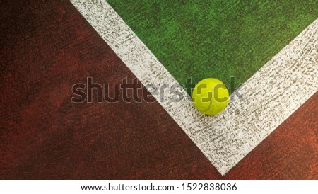 Yellow tennis ball hitting the sidelines on an green and orange artificial tennis court, sport background