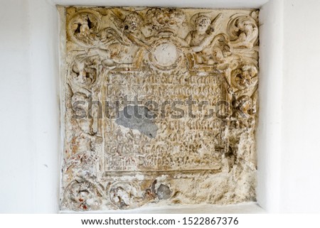 Ancient bas-relief with an inscription in old Russian in an Orthodox monastery