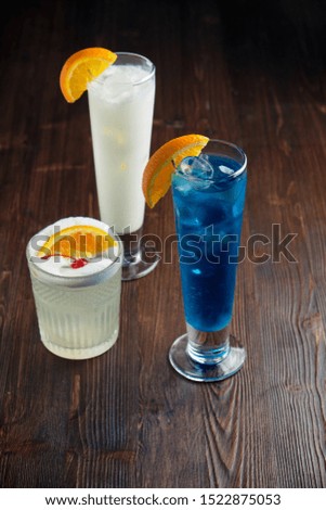 Different alcoholic cocktails on a dark wooden background. catering menu