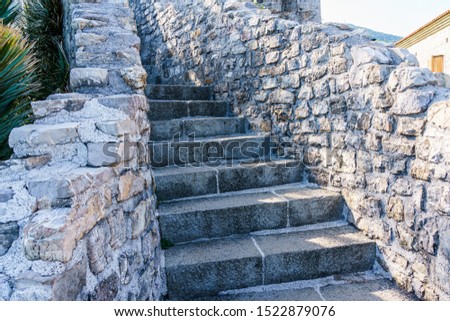 Architecture of the Balkan countries. A stone staircase with fences inside an ancient fortress.